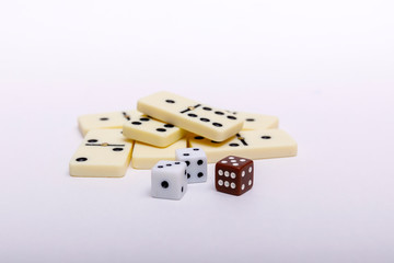 Domino and dice in front of white background