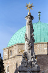 Holy Trinity statue with the mosque of pasha Qasim the Victorious in Pecs