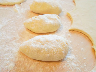 Fototapeta na wymiar Flour dough with filling. Homemade meal with flour. Dish of Russian cuisine, fried pies