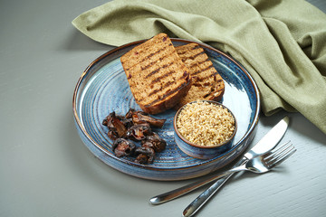 Fresh homemade chicken or duck liver pate with bread, croutons in blue plate. Copy space. Restaurant food. Antipasto
