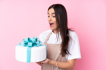 Young woman with a big cake over isolated background