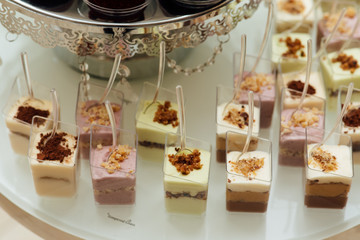 Delicious sweets on candy buffet. Candy bar on wedding ceremony with a lot of different candies. Details of a tasty candy bar of sweets, cookies , sweets concept.