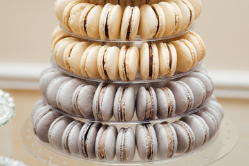 Delicious candy bar with macaron. Macaroni pyramids. Sweets on the table for the wedding.