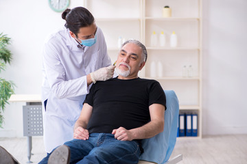 Old man visiting young doctor for plastic surgery