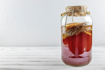 Kombucha superfood pro biotic tea fungus beverage in glass bottle and jar on white background