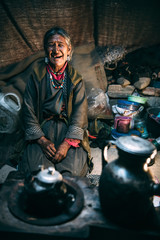 Nomadic old Woman. They live for several months a year in tents, looking for fresh pastures for their goats, from which comes cashmere wool. In Ladakh, Kashmir, India. - 325795136