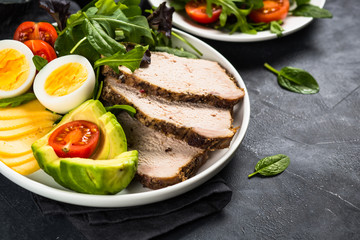 Keto diet plate on black stone table.