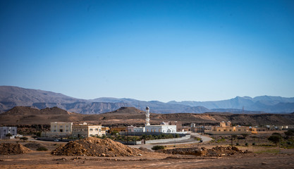 Mosque with a mountain in the background towards Sur, Oman