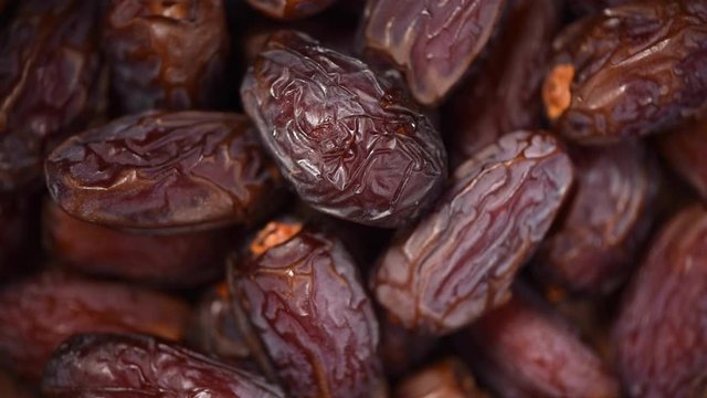 Dried date fruit rotatation. Dried fruits background. Fresh sweet dates, organic food. Food ingredient background. Vegan, vegetarian diet. Healthy lifestyle.