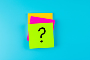 Questions Mark ( ? ) word in paper note on blue background. FAQ( frequency asked questions),...