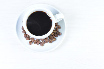 Colombian coffee cup with coffee beans on white wooden background