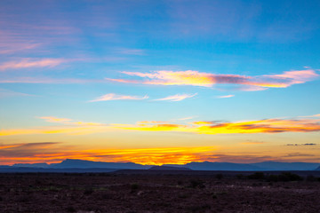 Yellow clouds and blue mountains at sunset in the Karoo