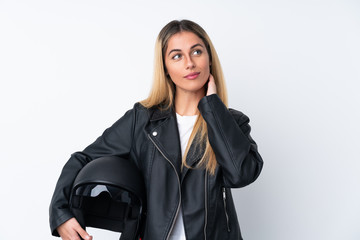 Young Uruguayan woman with a motorcycle helmet over isolated white background thinking an idea