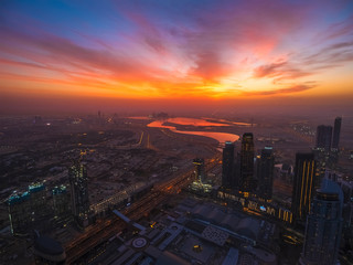 Naklejka na ściany i meble Dubai skyline aerial view at sunrise. Beautiful landscape of United Arab Emirates modern city from above.