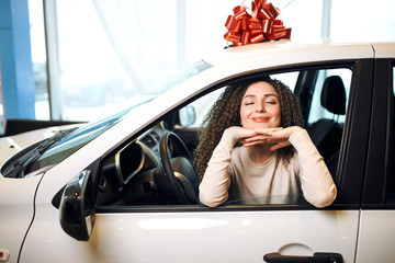 best present on birthday, st. valentine's day. young woman . delight, fun, joy. close up photo.red bow is on the top of white car - 325800185