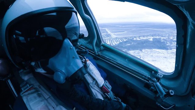 A helmeted pilot makes a landing