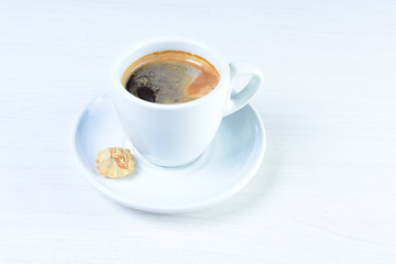 Cup of hot coffee white wooden background