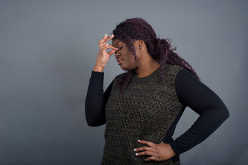 Very upset, charming, nice woman touching nose between closed eyes, want to cry, having stressful...