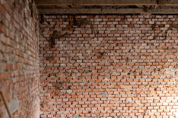 Detail of an ancient red brick wall slightly bleached with salt. The bricks were blocked by metal tie rods. Background use