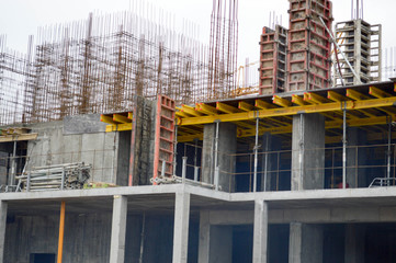 The process of construction and repair of a new modern cement concrete stone pannel monolithic frame-block building of a house with iron reinforcement at an industrial construction site