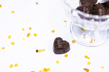 Chocolate candies with a heart on a light background