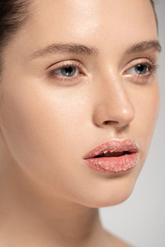 Beautiful Girl With Coconut Scrub On Lips, Isolated On Grey