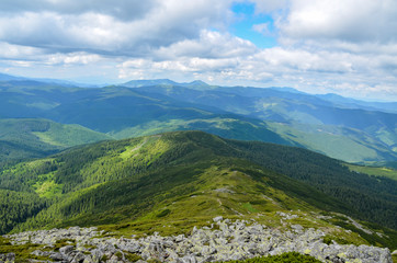 Fototapeta na wymiar Picturesque Carpathian mountains landscape, view from the height.Mountain range Chornohora with its spurs in the Carpathian Mountains in summer. View from the top of mount Pip Ivan, Ukraine