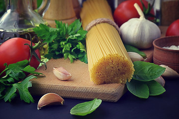 ingredients spaghetti pasta. Mediterranean italian dinner concept background. pasta, garlic, olive oil, basil, tomatoes.
