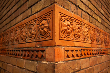 Red brick walls with beautiful decor elemets. Text space. Creative angle. Vintage, retro style. Outdoor shot