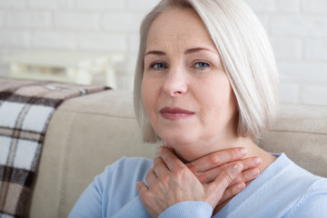 Sore throat woman at home.