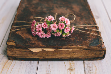 Vintage books with bouquet of flowers/ nostalgic vintage background