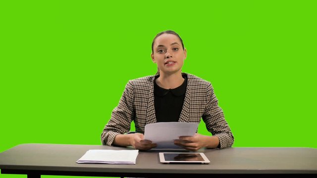 A female newsreader presenting the news, add your own text or image screen behind her on a Green Screen, Chroma Key.
