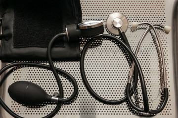 A device for measuring blood pressure on a metal table.