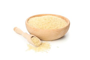 Wooden bowl and scoop with rice isolated on white background