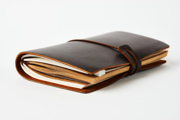 Handmade paper diary notebook in brown leather cover, close-up.