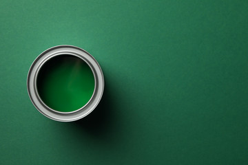 Paint can on green background, top view