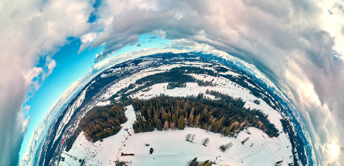 Beautiful panoramic aerial drone view to the ski slopes with lifts in the Bialka Tatrzanska ski resort Tatra Mountains (Tatras, Tatra) - mountain in Poland - 360 spherical panorama, little planet