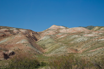 Red mountains in Xizi, Azerbaijan. Colorful hills . olorful geological formations . Red striped hills, rainbow mountains . View of the beautiful striped red mountain .