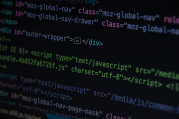 Close up css HTML code on monitor screen with black background