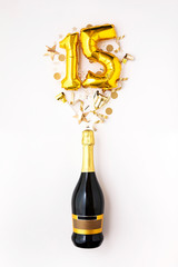 Happy 15th anniversary party. Champagne bottle with gold number balloon.