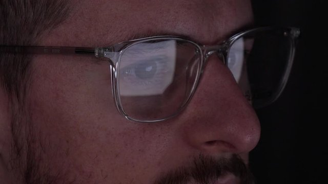 Computer hacker checking developer codes in the dark, closeup 