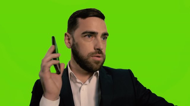 Man pushes a microphone with his hand, no comments concept. Isolated green screen.