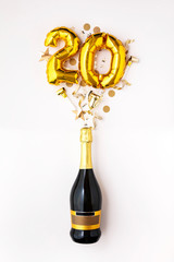 Happy 20th anniversary party. Champagne bottle with gold number balloon.