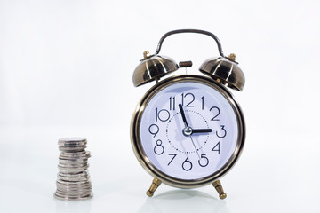 TIME IS MONEY concept: Alarm clock and with coins