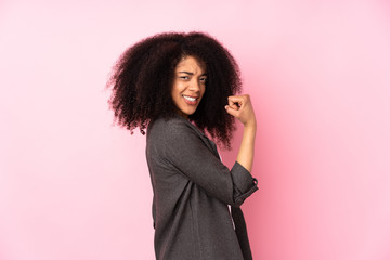 Young african american woman over isolated background celebrating a victory