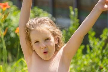 The child raises his hands in a joyful outburst.