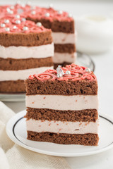 Homemade chocolate cake with cream and raspberries mousse, pink decoration. Homemade.