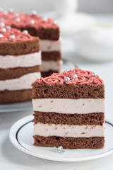 Homemade chocolate cake with cream and raspberries mousse, pink decoration. Homemade.