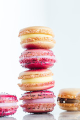 Assorted French macarons stacked on top of one another