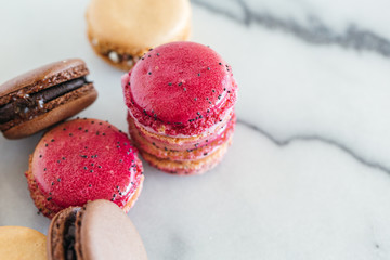 Assorted macarons on marble background